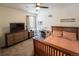 Comfortable bedroom with a ceiling fan, large dresser, and an adjacent workstation at 1056 S Elk Way, Aurora, CO 80018