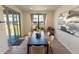 Bright dining room with natural light, modern art, and access to the outdoor patio at 1056 S Elk Way, Aurora, CO 80018