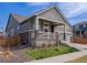 Charming front elevation with stone accents, landscaped yard, and inviting porch at 1056 S Elk Way, Aurora, CO 80018