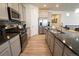 Spacious kitchen with stainless steel appliances, granite countertops, and hardwood floors at 1056 S Elk Way, Aurora, CO 80018