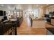 Open-concept living space with a modern kitchen and dining area with hardwood floors at 1056 S Elk Way, Aurora, CO 80018