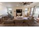 Spacious living room with comfortable seating, a modern ceiling fan, and natural light at 1056 S Elk Way, Aurora, CO 80018