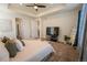 Comfortable primary bedroom with a ceiling fan and a view into the ensuite bathroom at 1056 S Elk Way, Aurora, CO 80018