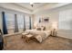 Main bedroom with large windows, cozy carpet, and tray ceiling at 1056 S Elk Way, Aurora, CO 80018