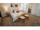 Cozy main bedroom featuring soft carpet, soft lighting, and artwork at 1056 S Elk Way, Aurora, CO 80018