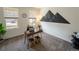 Bright home office featuring a modern desk, stylish decor, and natural light from windows at 1056 S Elk Way, Aurora, CO 80018
