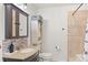 Bathroom featuring tiled shower, vanity with granite countertop and a coordinating vanity cabinet at 2569 Devonshire Ct # 72, Denver, CO 80229