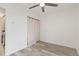 Bedroom featuring a ceiling fan and closet with a privacy curtain at 2569 Devonshire Ct # 72, Denver, CO 80229
