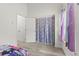 Bedroom view showcasing a closet with rainbow curtains, neutral paint, and light-colored flooring at 2569 Devonshire Ct # 72, Denver, CO 80229