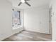 Cozy bedroom with a window, ceiling fan, and light-colored wood flooring at 2569 Devonshire Ct # 72, Denver, CO 80229