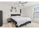 Well-lit bedroom featuring a bed, side tables, and light-colored wood flooring at 2569 Devonshire Ct # 72, Denver, CO 80229