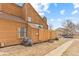 Exterior elevation with fenced in patio and car parking at 2569 Devonshire Ct # 72, Denver, CO 80229