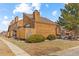 Exterior elevation with lush yard and two-car parking at 2569 Devonshire Ct # 72, Denver, CO 80229