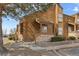 Charming multi-level home featuring wood siding, stone accents, and a landscaped front yard at 2569 Devonshire Ct # 72, Denver, CO 80229