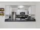 Modern kitchen view showcasing granite countertops, white cabinets, and stainless steel appliances at 2569 Devonshire Ct # 72, Denver, CO 80229