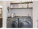Laundry room featuring a pair of Samsung washing machines and well-organized shelving for supplies at 2569 Devonshire Ct # 72, Denver, CO 80229