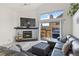 Cozy living room with a stone fireplace, sliding glass door, and comfortable furnishings at 2569 Devonshire Ct # 72, Denver, CO 80229