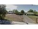 Street view of a property with a partially fenced yard and an unpaved driveway at 971 S Wolff St, Denver, CO 80219