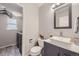 Contemporary bathroom with modern vanity, stylish fixtures, and a laundry room in the back at 13212 Clermont Cir, Thornton, CO 80241