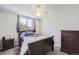 Cozy bedroom with window, dresser, and stylish gray bedding and matching curtains at 13212 Clermont Cir, Thornton, CO 80241