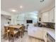 Bright dining area with white cabinets and a clear view of the living room at 13212 Clermont Cir, Thornton, CO 80241