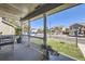 Inviting covered front porch, featuring white railings, a seating area and a view of the neighborhood at 13212 Clermont Cir, Thornton, CO 80241