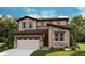 Charming two-story home featuring a stone facade, attached garage, and a beautifully landscaped front yard at 7015 E 126Th Dr, Thornton, CO 80602