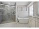 Bright bathroom with soaking tub, stand up shower and marble floors at 10058 Glenstone Cir, Highlands Ranch, CO 80130