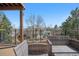 Cozy outdoor deck with wicker seating and a view of the fenced backyard and nearby homes at 10058 Glenstone Cir, Highlands Ranch, CO 80130