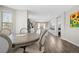 Bright dining area features light wood floors, modern chandelier, and open access to the kitchen at 10058 Glenstone Cir, Highlands Ranch, CO 80130