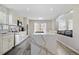 Modern kitchen featuring a large island, sleek cabinetry, stainless steel appliances, and wood floors at 10058 Glenstone Cir, Highlands Ranch, CO 80130