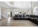 Bright living room with an open layout flowing into the kitchen, light wood floors, and natural light at 10058 Glenstone Cir, Highlands Ranch, CO 80130