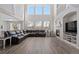 Inviting living room with a fireplace, light wood floors, large windows, and a comfortable sectional sofa at 10058 Glenstone Cir, Highlands Ranch, CO 80130