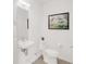 Bright bathroom featuring a stylish sink, toilet, and framed art adding a touch of elegance at 1238 Quitman St # 2, Denver, CO 80204