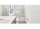Bright bathroom featuring a glass-enclosed shower and a sleek vanity with ample counter space at 1238 Quitman St # 2, Denver, CO 80204