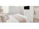 Bright bedroom features a comfy bed and sleek wall-mounted TV for comfortable viewing at 1238 Quitman St # 2, Denver, CO 80204