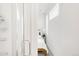 Bathroom view through shower showcasing bright bedroom with natural light and simple decor at 1238 Quitman St # 2, Denver, CO 80204