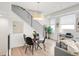 Dining room with modern light fixtures, a round table, and a view of the living area at 1238 Quitman St # 2, Denver, CO 80204