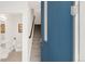 Inviting entryway with a blue door, stairs, and a glimpse into the adjacent bathroom at 1238 Quitman St # 2, Denver, CO 80204