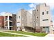 Modern townhome exteriors showcasing gray siding, brick accents, well-maintained lawns, and blue sky at 1238 Quitman St # 2, Denver, CO 80204