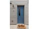 Stylish blue front door with glass inset, siding, and a welcoming 'hello' doormat at 1238 Quitman St # 2, Denver, CO 80204