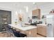 Bright kitchen featuring an island with seating, stainless steel appliances, and modern cabinetry at 1238 Quitman St # 2, Denver, CO 80204