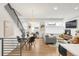 Inviting living space with dining area featuring contemporary decor and staircase with iron railings at 1238 Quitman St # 2, Denver, CO 80204
