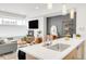 Bright and open living space featuring a fireplace and direct view into the kitchen at 1238 Quitman St # 2, Denver, CO 80204