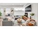 Comfortable living room featuring a gray sofa, fireplace, entertainment center, and bright natural light at 1238 Quitman St # 2, Denver, CO 80204