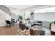 Bright living space with modern furniture, light wood floors, and staircase with iron railings at 1238 Quitman St # 2, Denver, CO 80204