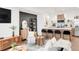 Open-concept living and kitchen area with modern decor and a kitchen island with bar stools at 1238 Quitman St # 2, Denver, CO 80204