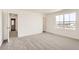 Bright bedroom featuring neutral carpet and a closet, offering a serene retreat at 3919 N Shawnee St, Aurora, CO 80019