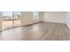 Bright living room featuring luxury vinyl plank flooring and a sliding glass door at 3919 N Shawnee St, Aurora, CO 80019