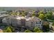 Apartment building with surrounding trees and cityscape in the background at 2200 S University Blvd # 513, Denver, CO 80210